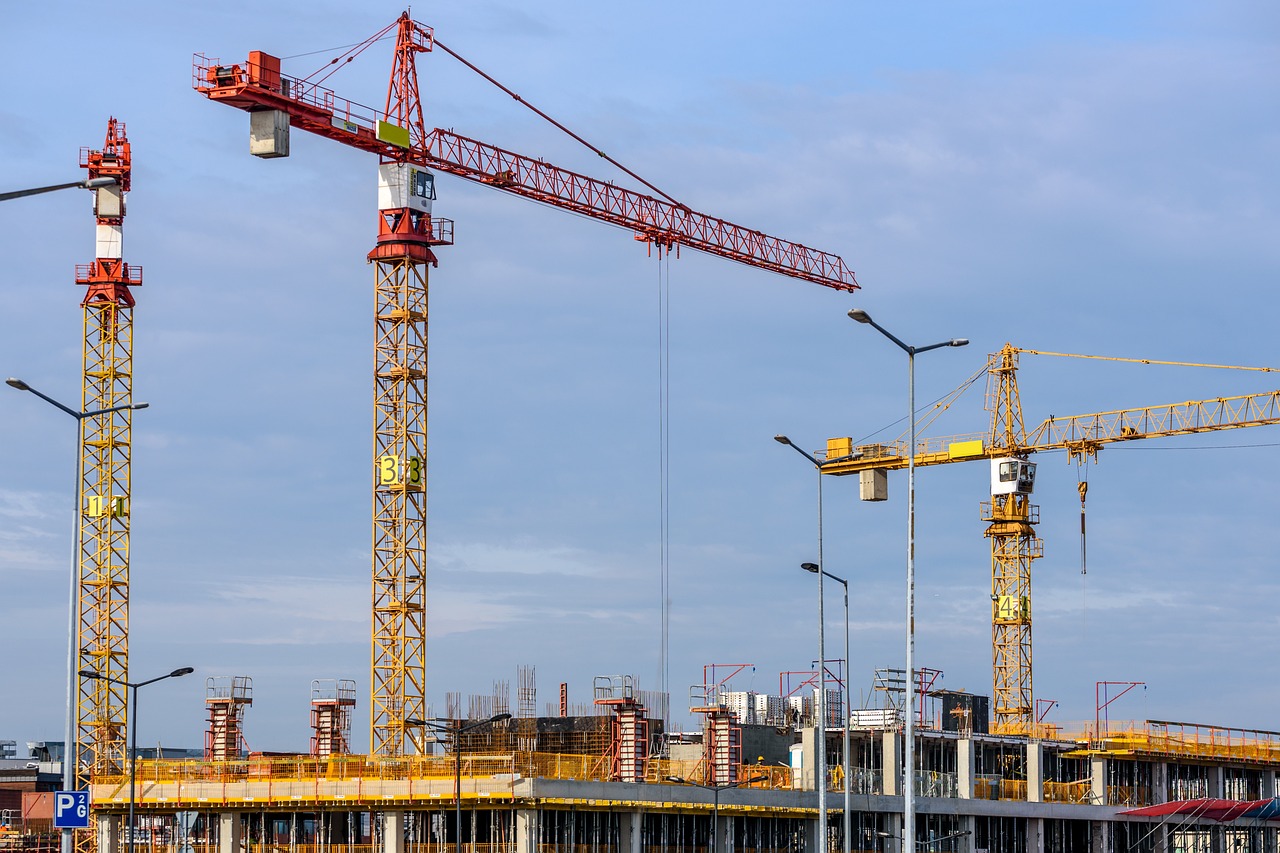 Three Yellow Tower cranes on a building site