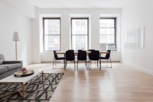 flat with wooden floor, sofa and dinning table and chairs